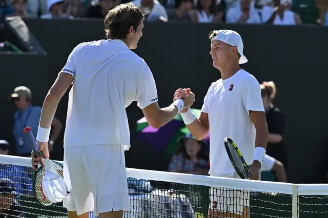 Holger Rune and Nicholas Jarry shake hands at the net