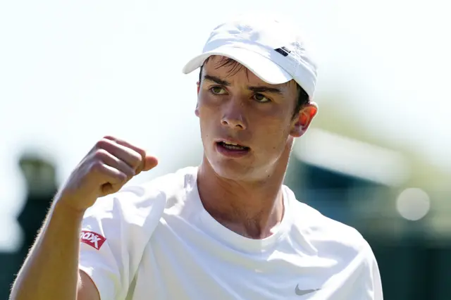Oliver Tarvet celebrates victory at Wimbledon