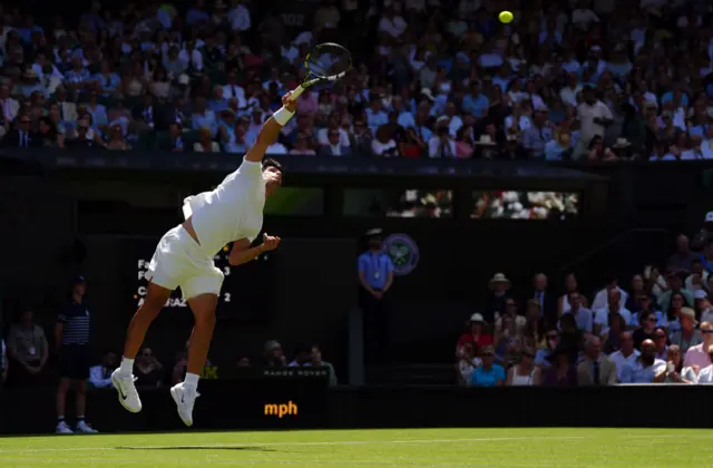 Carlos Alcaraz serves at Wimbledon