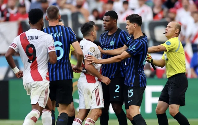 River Plate's Marcos Acuna clashes with Inter Milan's Denzel Dumfries before being shown a second yellow then red card