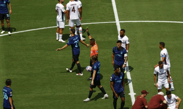 Inter Milan's Kristjan Asllani is shown a yellow card
