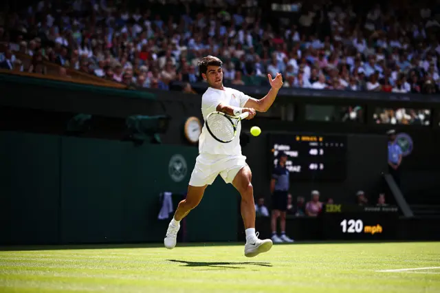 Carlos Alcaraz hits a forehand at Wimbledon