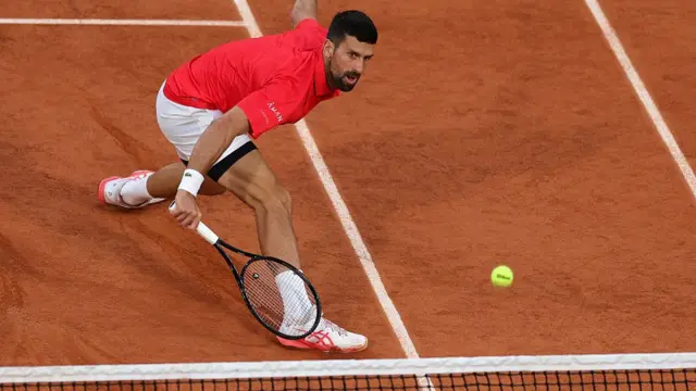 Novak Djokovic plays a drop shot