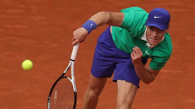 Jannik Sinner serves against Alexander Bublik