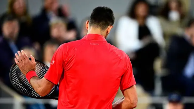 Novak Djokovic taps his racquet