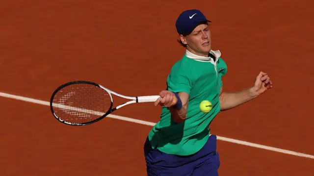 Jannik Sinner plays a forehand