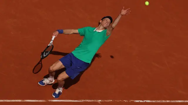 Jannik Sinner serves