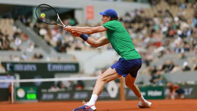 Jannik Sinner hits a backhand
