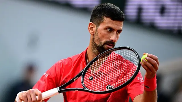 Novak Djokovic serves