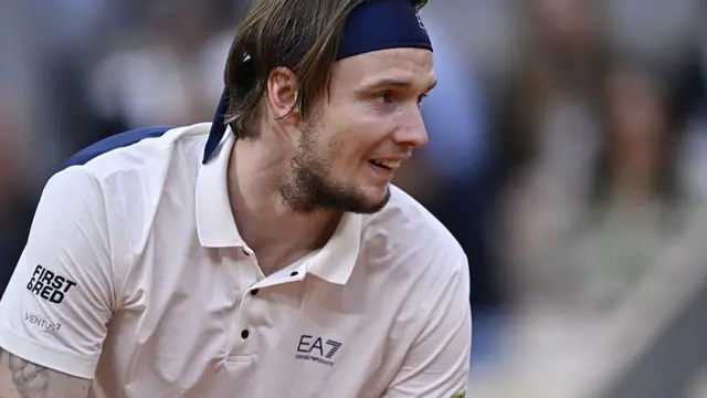 Aleksandr Bublik hunches over