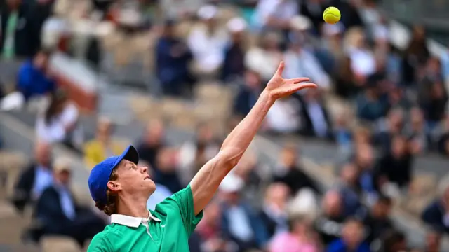 Jannik Sinner serves
