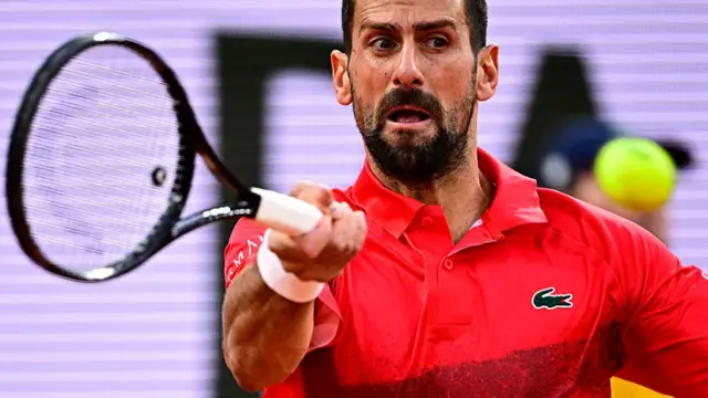 Novak Djokovic plays a forehand return