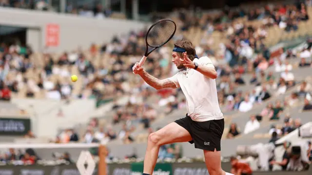 Alexander Bublik slices the ball