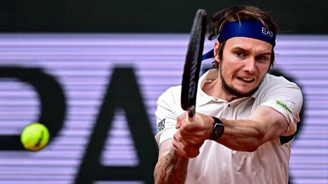 Alexander Bublik plays a backhand return