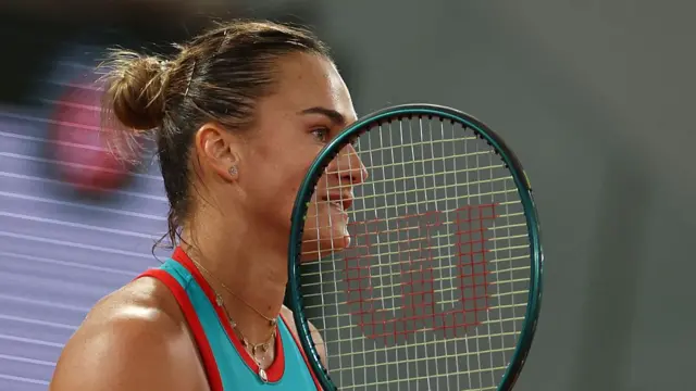 Aryna Sabalenka looks on
