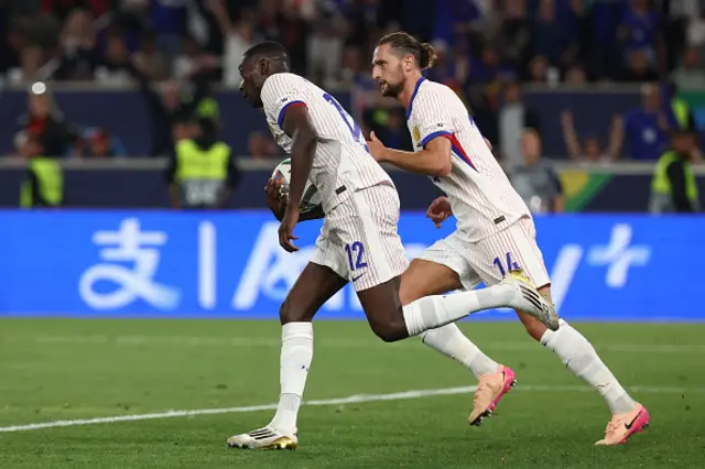 Randal Kolo Muani (L) celebrates scoring the 5-4 goal with his teammate France's midfielder #14 Adrien Rabiot