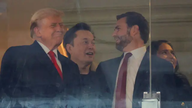 Musk chats with Donald Trump, JD Vance and Tulsi Gabbard at a football game.