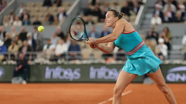 Aryna Sabalenka plays a backhand