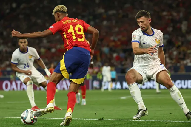 Lamine Yamal (L) and France's defender Clement Lenglet vie for the ball