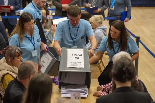 voting papers being turned out on to counting tables