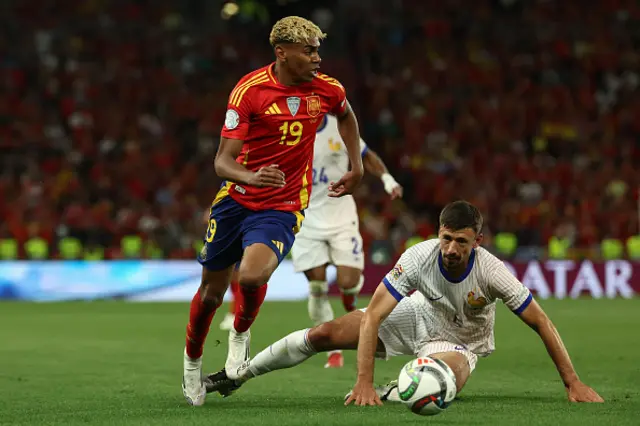 Lamine Yamal (L) gets past France's defender Clement Lenglet