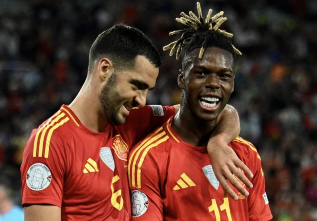 Spain's Nico Williams celebrates scoring their first goal with Spain's Mikel Merino