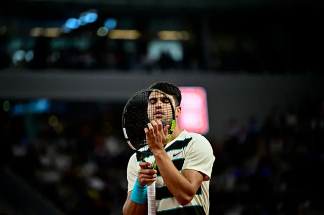 Spain's Carlos adjusts strings of his racket