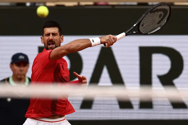 Serbia's Novak Djokovic plays a forehand return to Italy's Jannik Sinner