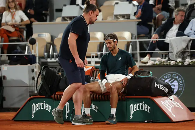 Lorenzo Musetti of Italy receives medical treatment