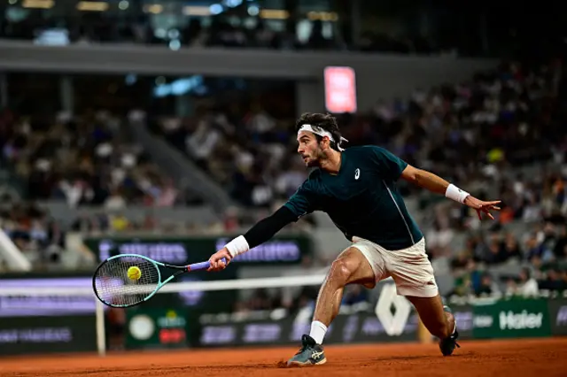 Italy's Lorenzo Musetti plays a backhand return to Spain's Carlos Alcaraz