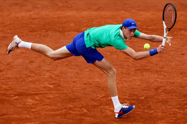 Jannik Sinner plays a backhand return to Serbia's Novak Djokovic