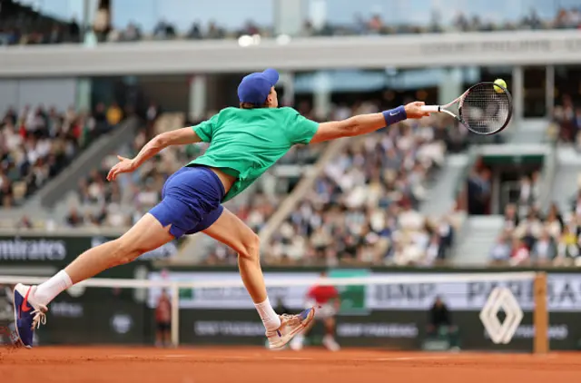 Jannik Sinner of Italy plays a forehand against Novak Djokovic