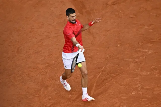Novak Djokovic of Serbia in action against Jannik Sinner