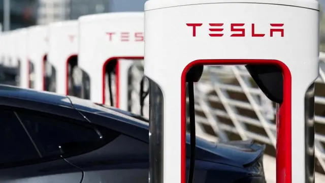 The logo of Tesla is pictured at a Tesla Super Charging station in Saint-Herblain near Nantes, France