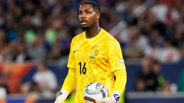 Goalkeeper Mike Maignan of France looks on