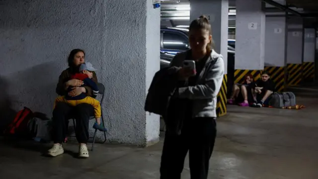Residents take shelter inside an underground parking facility during Russian drone strikes in Kyiv, Ukraine on 6 June 2025.