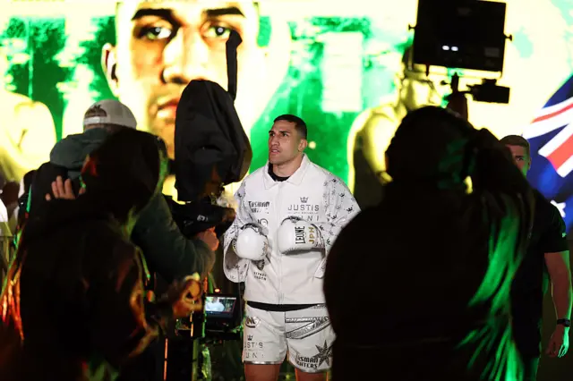 Justis Huni dressed all in white makes his ring walk