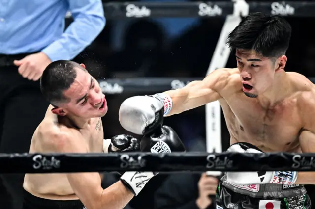 Kosei Tanaka punches Christian Bacasegua on the chin