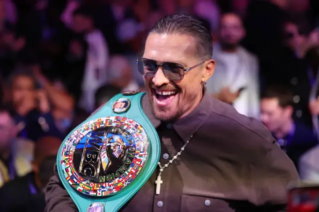 Oleksandr Usyk smiling with the WBC belt
