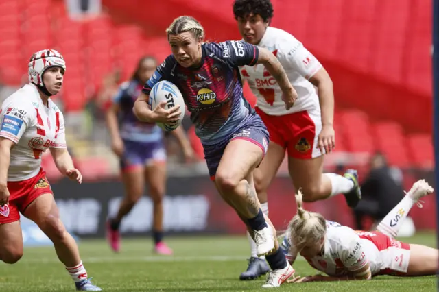 Wigan's Emily Veivers powers through the St Helens defence