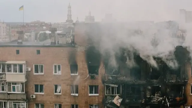 A fire breaks out in a residential apartment building due to a strike by a Russian drone