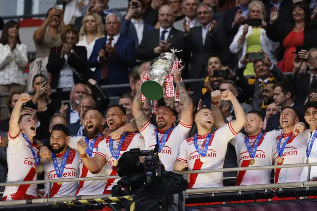Hull KR captain Elliot Minchella lifts the Challenge Cup