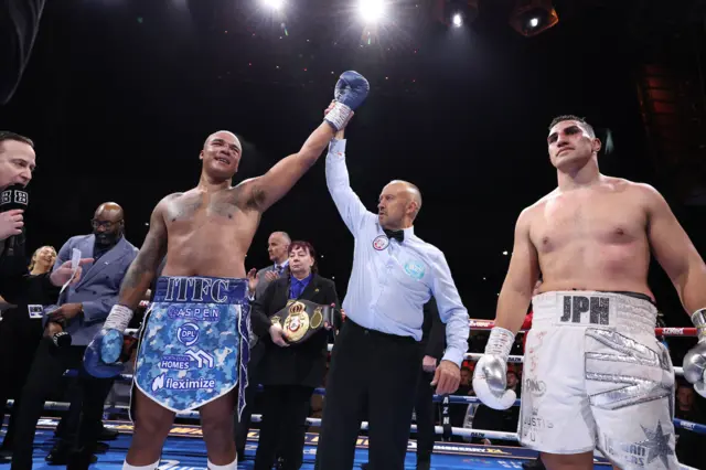 Fabio Wardley has his hand raised beside Justis Huni