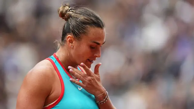 Aryna Sabalenka looks down