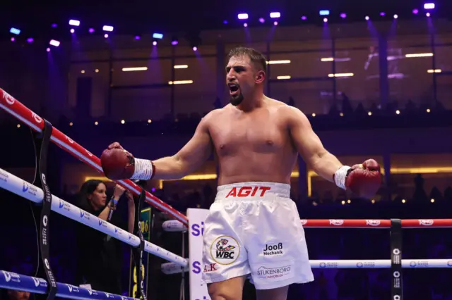 Agit Kabayel with his arms out in celebration