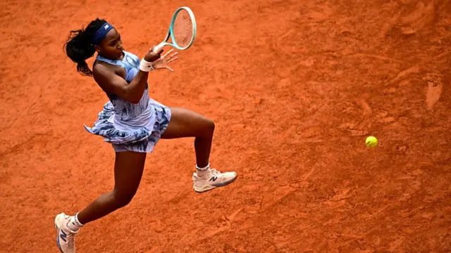 Coco Gauff jumps to play a forehand return