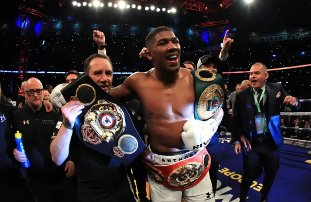 Anthony Joshua with his world championship belts