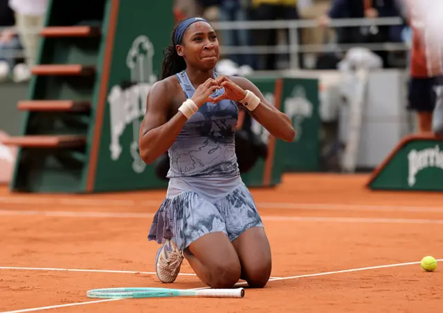 Coco Gauff makes a heart shape with her hands