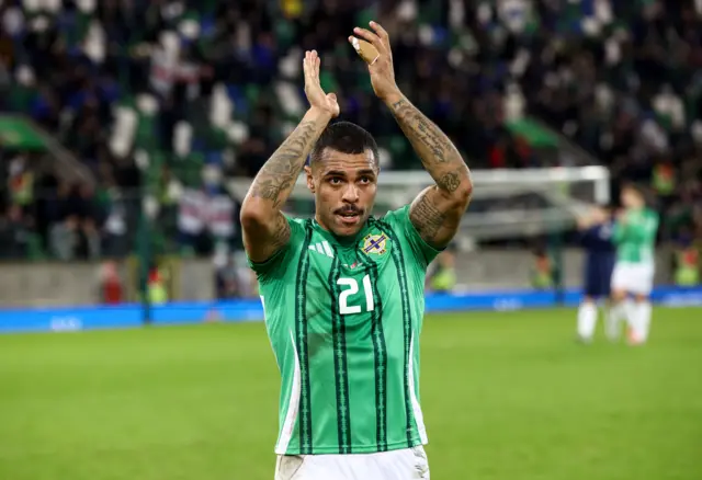 Josh Magennis applauds supporters