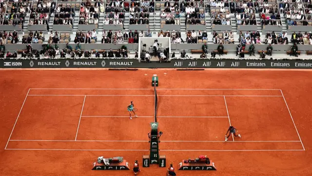 Coco Gauff hits a backhand past Aryna Sabalenka